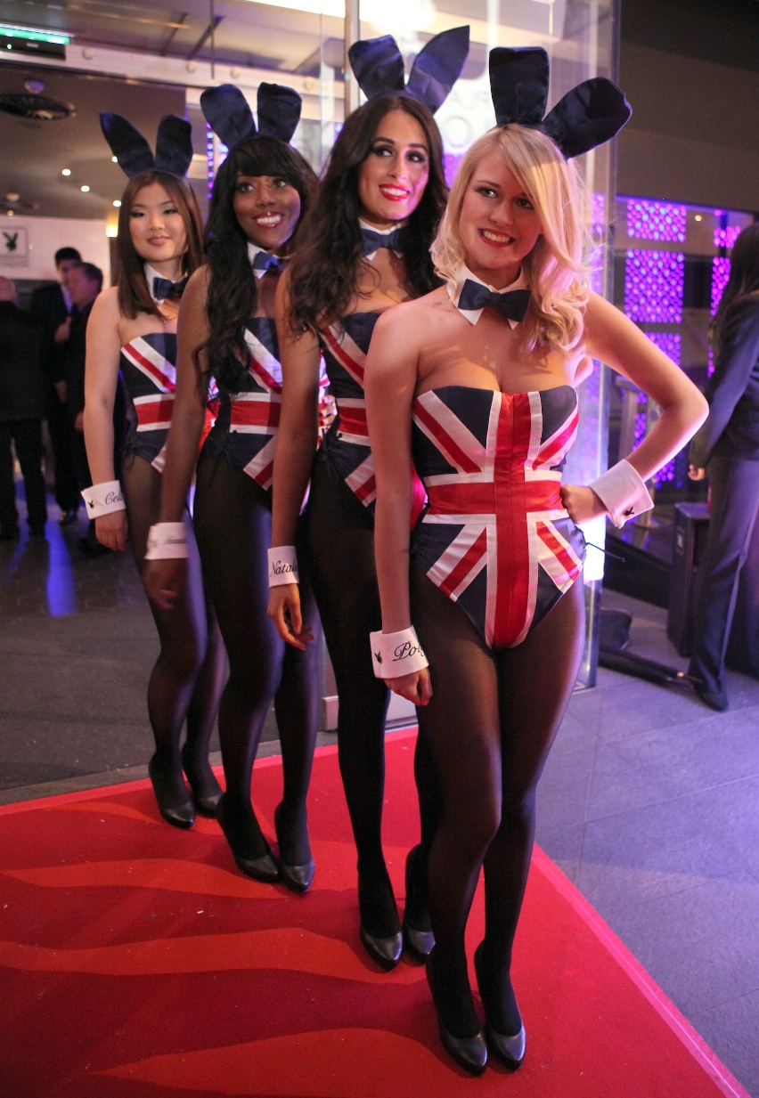 Four Bunny Girls wearing Black Opaque Nylon Tights, Stilettos and UK Flag Bodysuits
